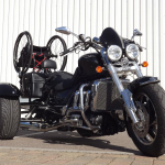Casarva Rocket 111 trike with disability adaptations. Reverse gearbox, raked front forks to make steering lighter, rigid frame wheelchair rack, Kliktronic gear shifter, K Lever2 twin brake levers, Footplates with back stops and velcro straps, Lap belt, reupholstered seat with special foam insert.